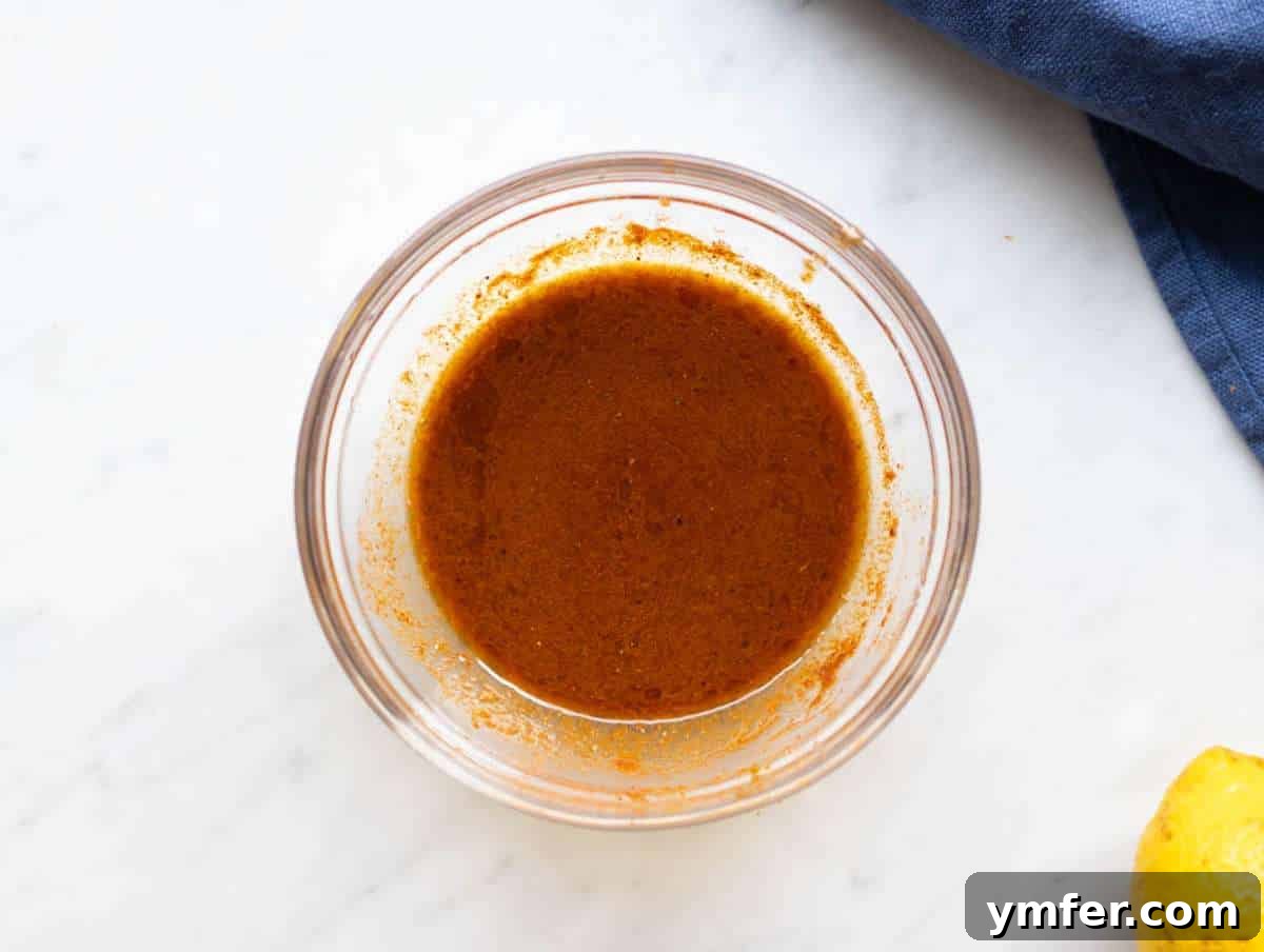 Step 1 Shawarma marinade for cauliflower shawarma bowl whisked with spices olive oil garlic and lemon.