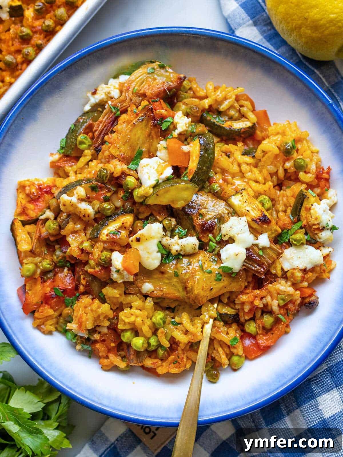 Effortless One-Pan Vegetable Paella 4 Easy Vegetable Paella in a bowl showing golden rice and colorful Mediterranean vegetables.