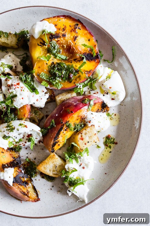 Sweet Smoky Peach Burrata Salad 2 Grilled peach burrata salad on a plate, featuring caramelized peaches, creamy burrata, and fresh mint.