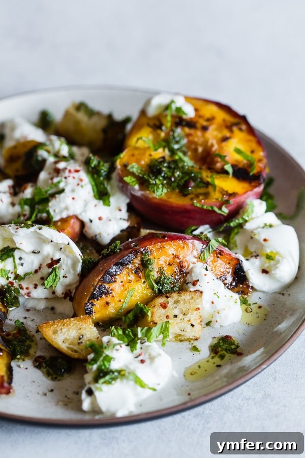 Sweet Smoky Peach Burrata Salad 3 A plate featuring a vibrant grilled peach burrata salad, showcasing its rich colors and textures.