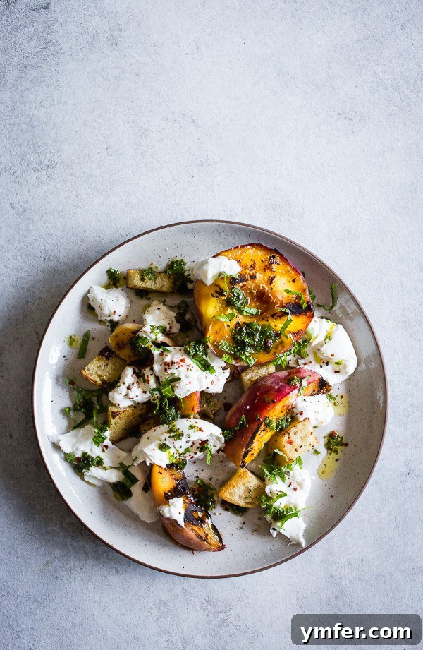 Sweet Smoky Peach Burrata Salad 4 An overhead view of a perfectly arranged grilled peach burrata salad on a plate.