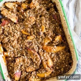 Ginger peach crisp in a small metal dish, ready for serving.