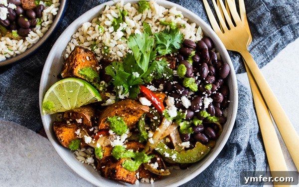 Sweet Potato Black Bean Fiesta Bowls 4 A delicious Sweet Potato Black Bean Burrito Bowl served with a fork, ready to be enjoyed.