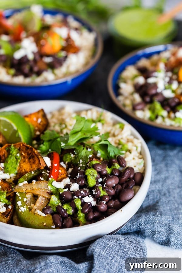 Sweet Potato Black Bean Fiesta Bowls 5 A vibrant Sweet Potato Black Bean Burrito Bowl with cilantro dressing drizzled on top, ready to serve.