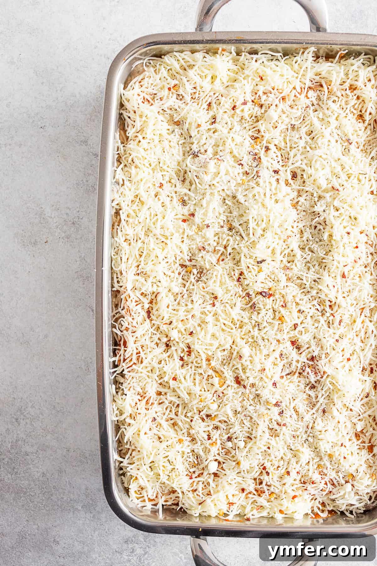 Hearty Italian Sausage Lasagna 3 Italian Sausage Lasagna uncooked in a deep baking dish, ready for the oven.