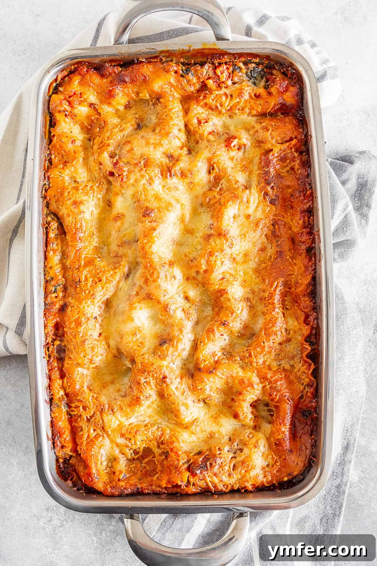 Hearty Italian Sausage Lasagna 4 Italian Sausage Lasagna baking in a pan, bubbling with cheese and sauce.