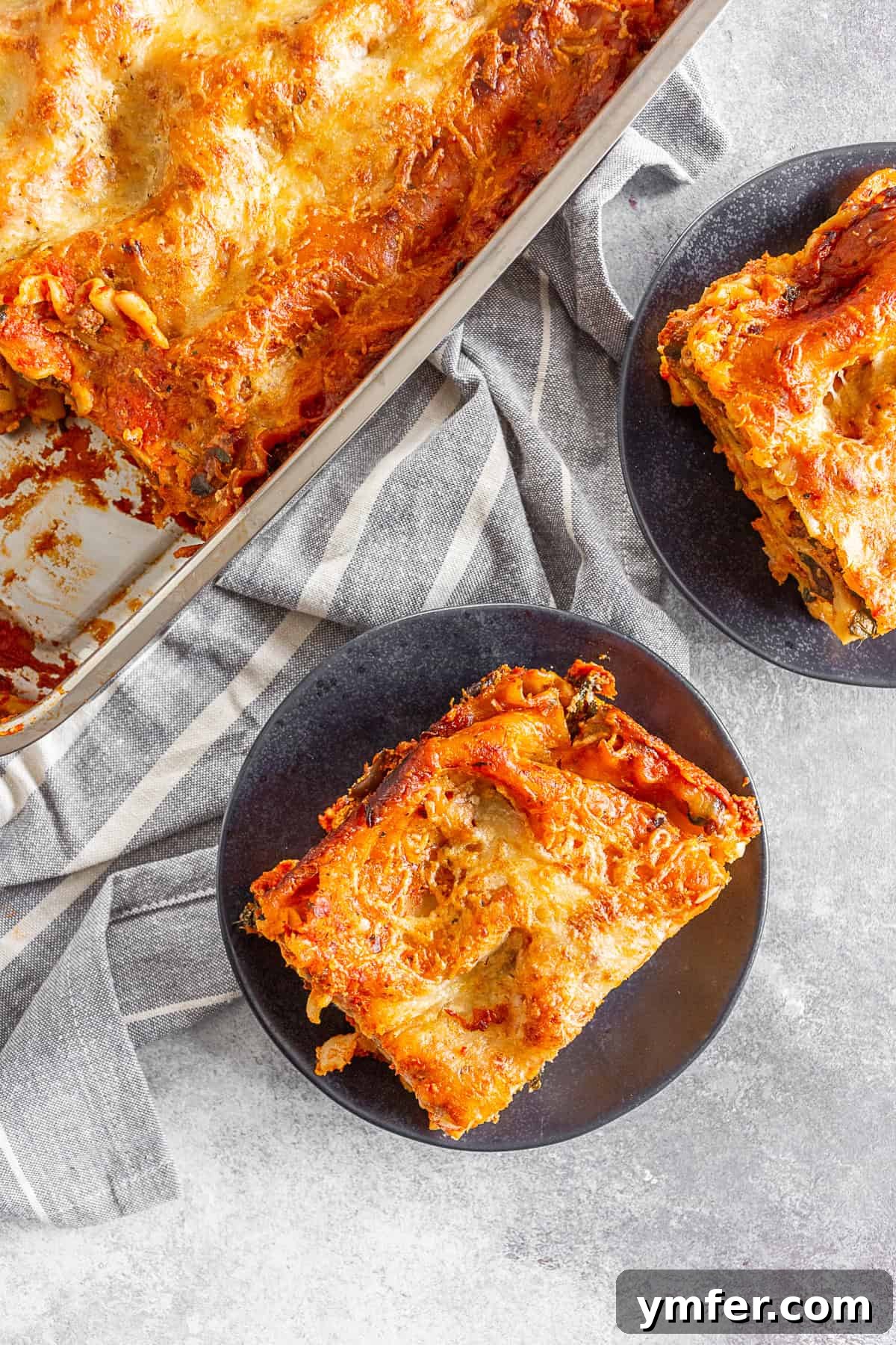 Hearty Italian Sausage Lasagna 5 Two plates with generous slices of Italian Sausage Lasagna, ready to be enjoyed.