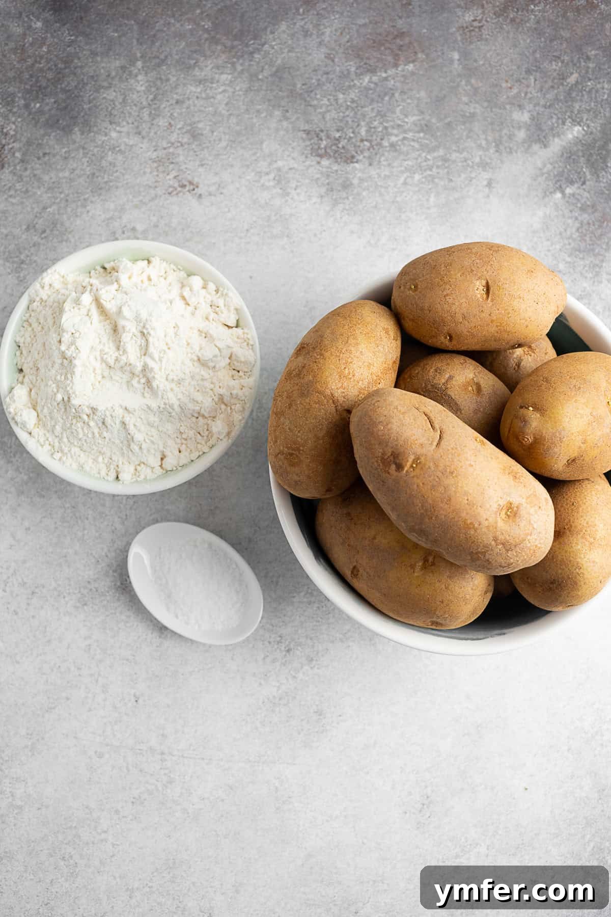 Slovak Bryndza Potato Dumplings 3 Potatoes, flour, and kosher salt on a table.