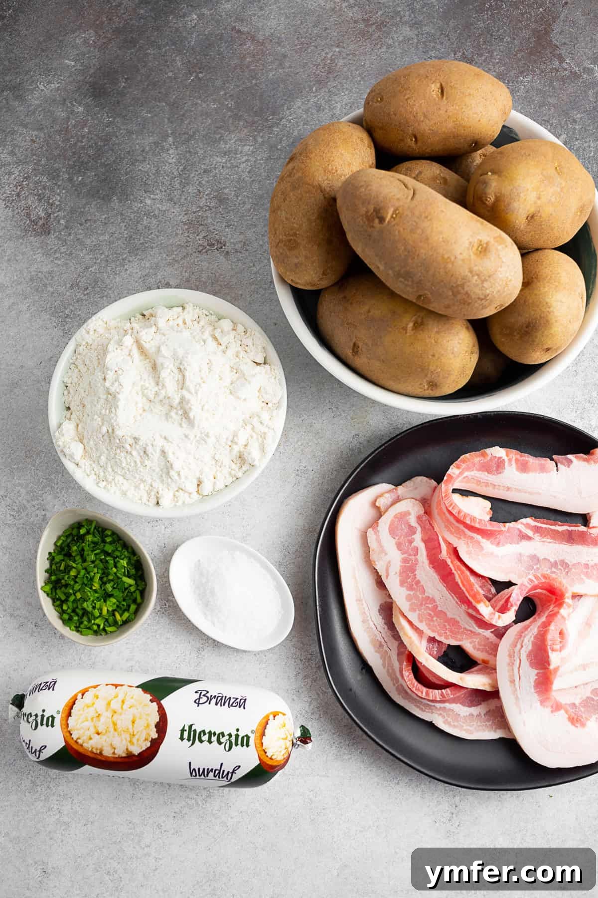 Slovak Bryndza Potato Dumplings 4 Potatoes, flour, bacon, chives, kosher salt, and cheese on a table.