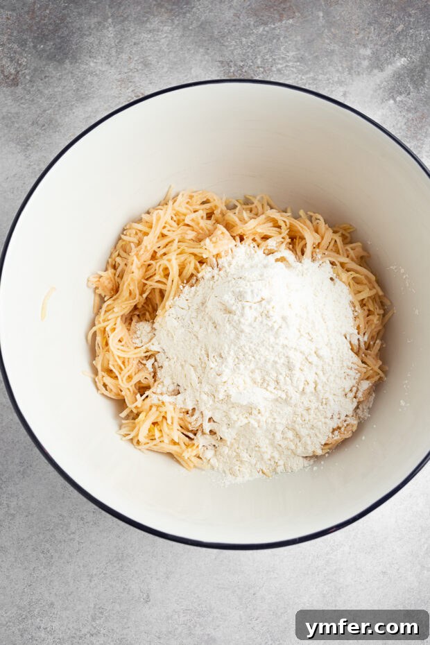 Slovak Bryndza Potato Dumplings 5 Shredded potatoes and flour in a bowl.