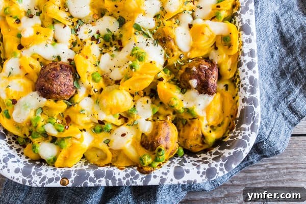 Autumn Comfort: Pumpkin Alfredo Meatball Pasta Bake 3 Close-up of Pumpkin Cauliflower Alfredo Meatball Pasta Bake garnished with fresh herbs, showcasing its rich texture.