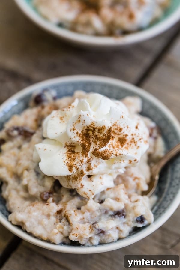 Creamy Vanilla Bean Brown Rice Bliss 4 A serving of Vanilla Bean Brown Rice Pudding garnished with whipped cream and cinnamon, highlighting its wholesome ingredients and appealing presentation.