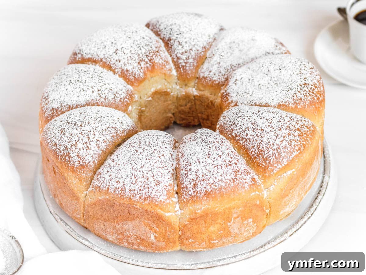 Heavenly Vegan Brioche 5 A freshly baked vegan brioche loaf, golden brown and perfectly risen, resting on a white plate.