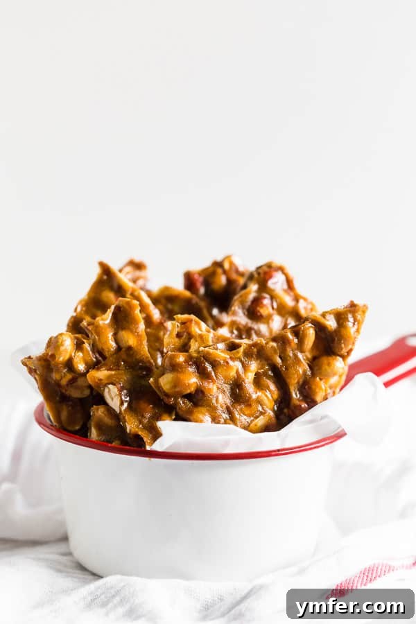 Golden Maple Peanut Brittle 3 Homemade Maple Peanut Brittle cooling on parchment paper, ready to be broken into pieces.