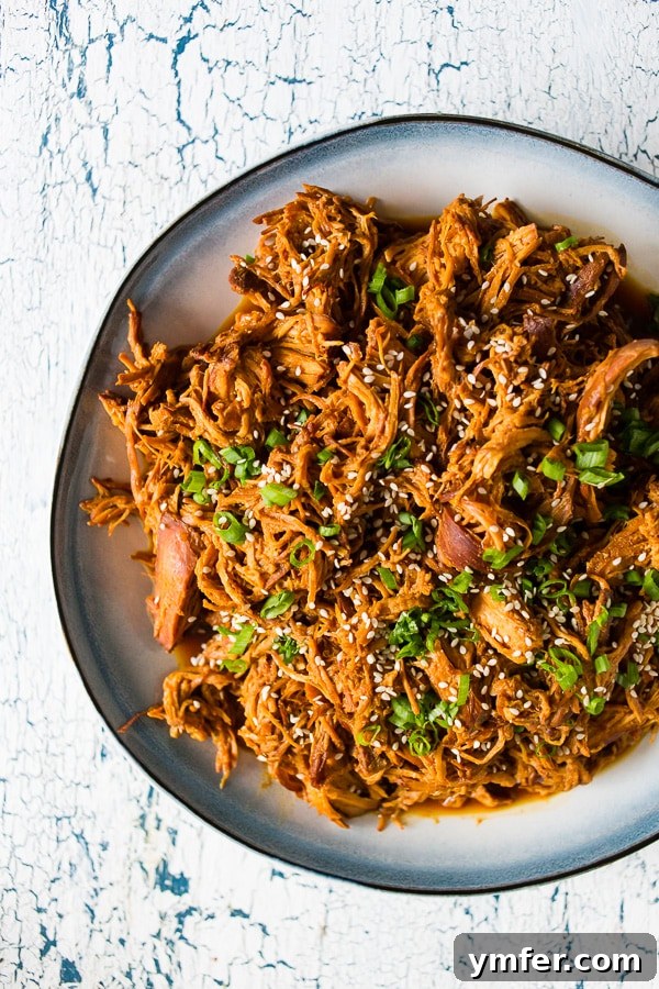 2017's Standout Content 6 Slow cooker honey soy sriracha pulled chicken: a flavor-packed, easy recipe made with just a few ingredients. Perfect served over rice or on a soft bun for a hearty meal.