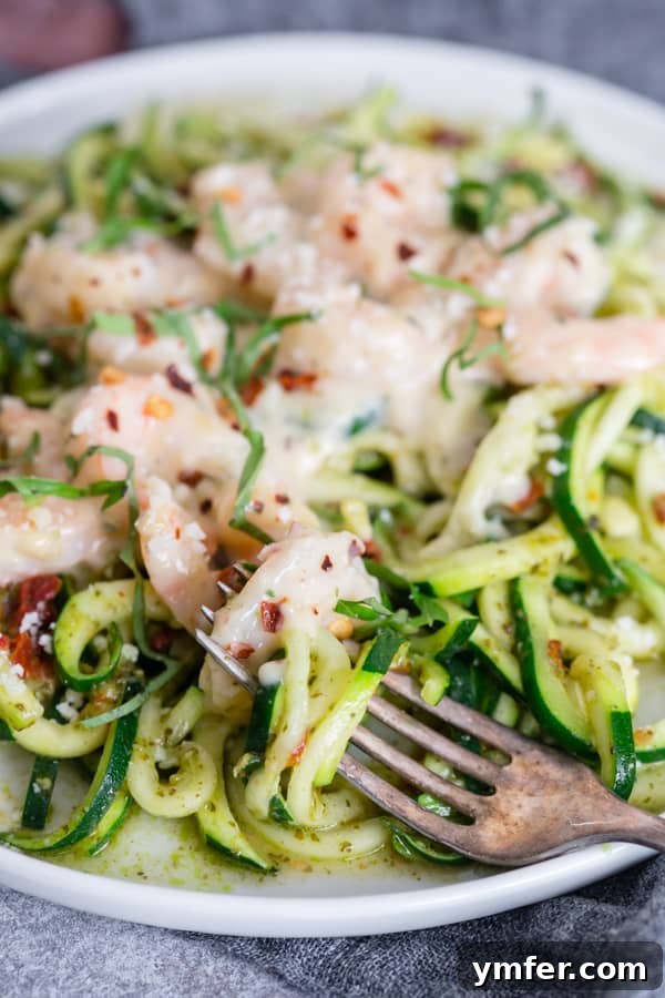 Vibrant Garlic Shrimp Pesto Zoodles 4 Plated garlic shrimp pesto zoodles, showing a generous serving of shrimp and zoodles.