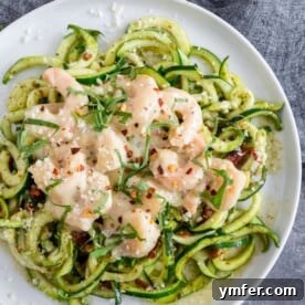 A serving of garlic shrimp pesto zoodles with fresh basil