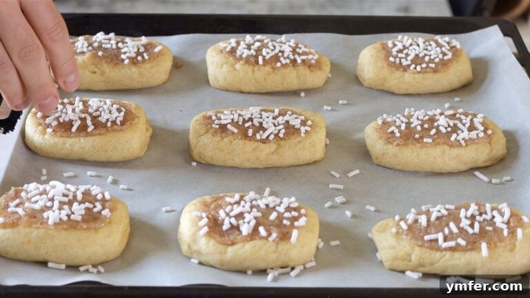 Brioches with glaze and pearl sugar ready to be baked
