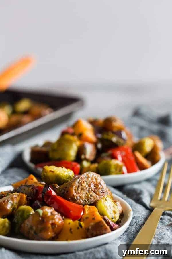 One-Pan Roasted Chicken Sausage and Garden Vegetables 3 Close-up of perfectly roasted chicken sausage chunks alongside caramelized Brussels sprouts and sweet potato cubes on a sheet pan.