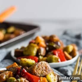 A beautifully roasted sheet pan chicken sausage and vegetables dinner, featuring golden chicken sausage, vibrant Brussels sprouts, sweet potatoes, and bell peppers.