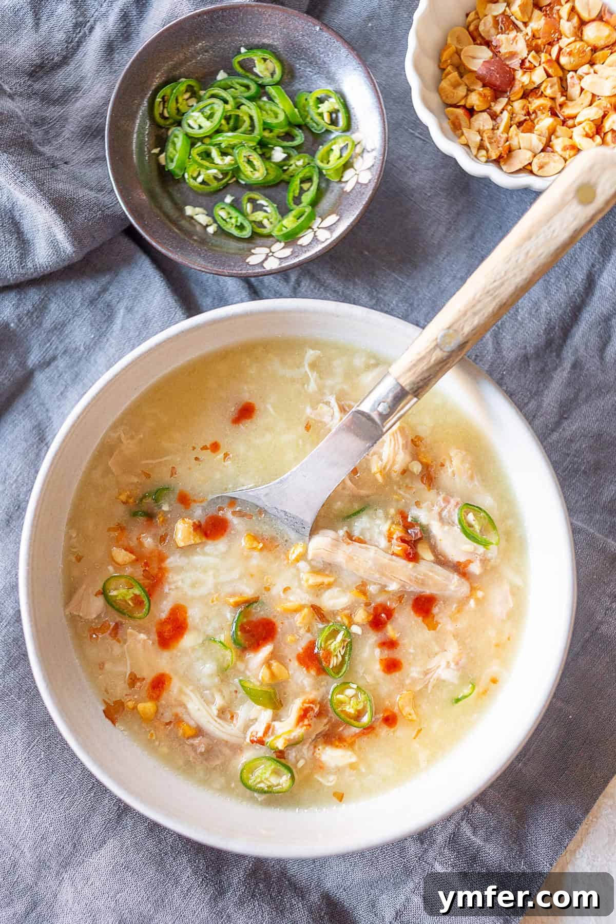 Comforting Instant Pot Asian Chicken Rice Soup 2 Instant Pot Asian Chicken and Rice Soup in a white bowl with a spoon.