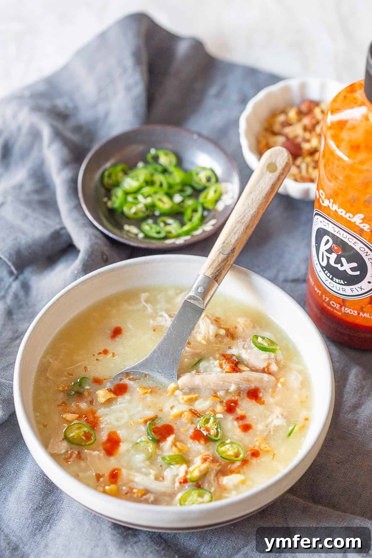 Comforting Instant Pot Asian Chicken Rice Soup 3 Instant Pot Asian Chicken and Rice Soup topped with sriracha.