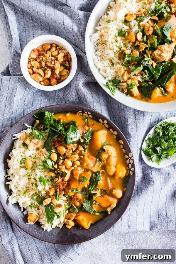 Soulful African Chicken and Peanut Stew 4 A serving of African Chicken Peanut Stew in a rustic bowl, alongside a bed of white rice, garnished with fresh herbs.