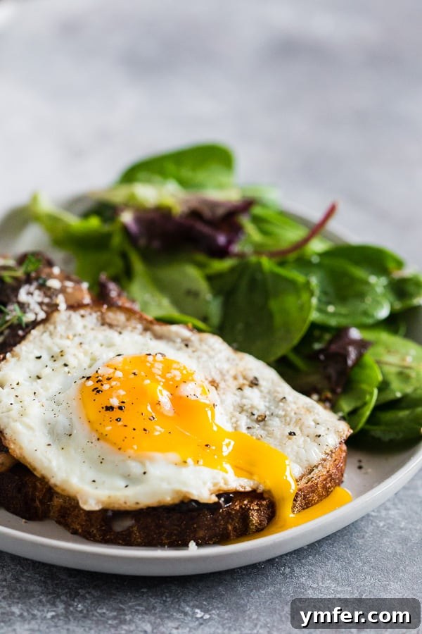 Garlicky Foraged Mushroom Toast 4 Garlic Wild Mushrooms on Toast with a runny egg, showing the cross-section of the toast and the creamy egg yolk.