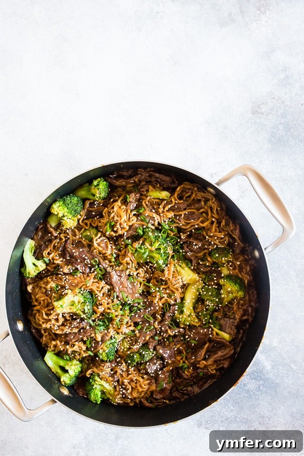 Beef and Broccoli Ramen Noodles cooking in a large, well-used pan.