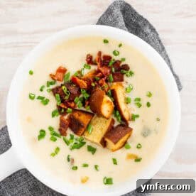 Champion Beer Cheese Soup 6 Beer Cheese Soup in a bowl topped with chives, bacon, and pretzel croutons.