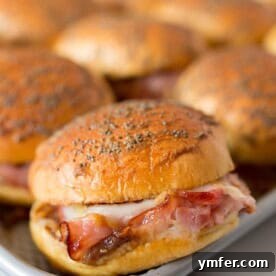 Delicious baked apple butter ham and cheese sliders in a baking tray, ready to serve.