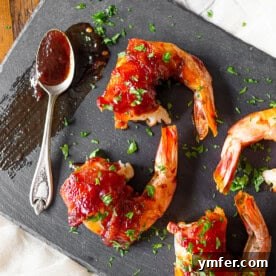 Succulent apple butter bacon-wrapped shrimp, glistening with a sweet and spicy glaze.