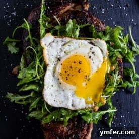 fried egg topped steak with arugula
