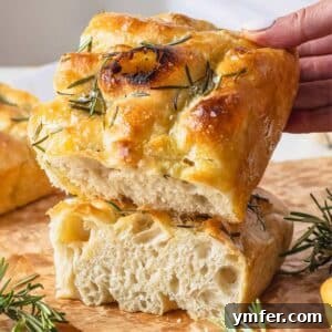 Golden Focaccia Perfection 12 Focaccia with rosemary and a hand