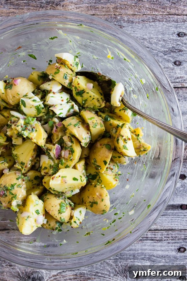 Sunshine Spud Salad 2 Honey Mustard Potato Salad with a bowl with a spoon, ready to be served.