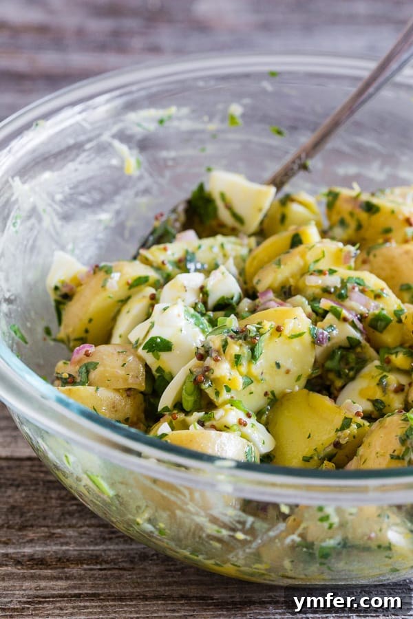 Sunshine Spud Salad 3 Honey Mustard Potato Salad topped with fresh herbs, ready to be served at a summer gathering.