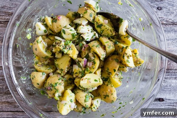 Sunshine Spud Salad 6 Honey Mustard Potato Salad in a clear glass bowl, showcasing its fresh, colorful ingredients.