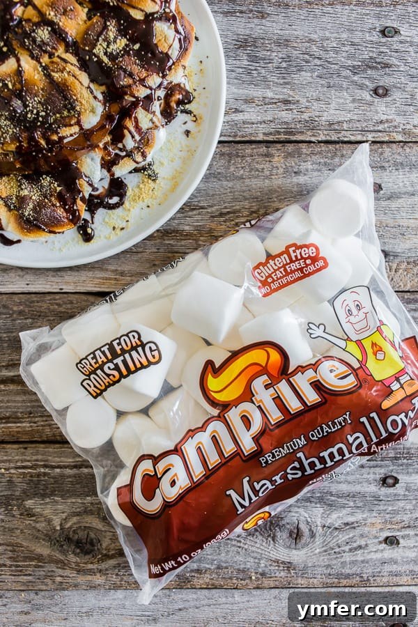 Gooey Smores French Toast 3 A stack of S'mores French toast on a white plate, with a bag of marshmallows in the background, highlighting the key ingredient.