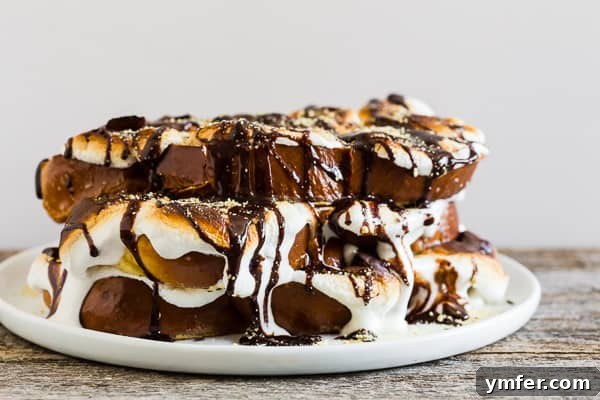 Gooey Smores French Toast 4 S'mores French toast stacked neatly on a white plate, ready to be served.