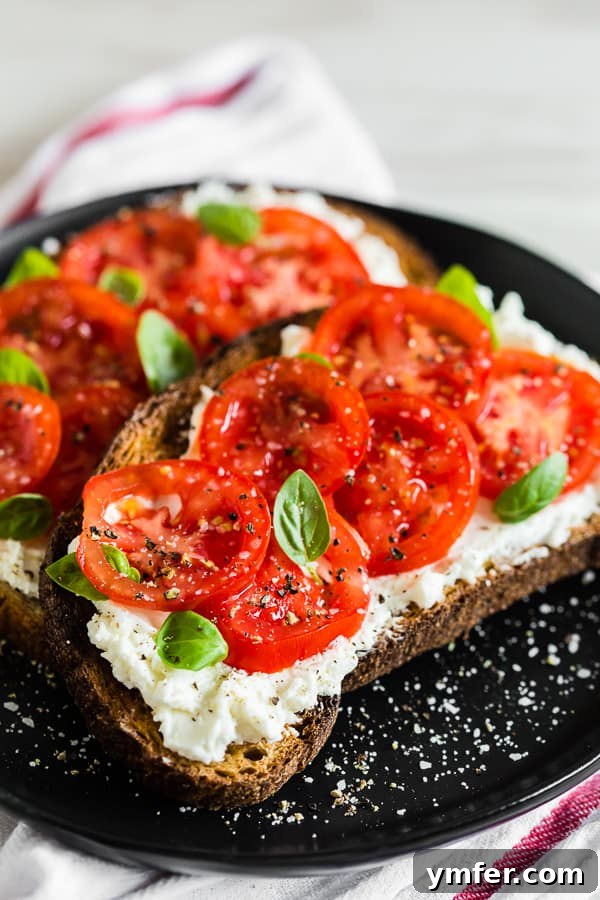 Tuscan Morning Toast 4 Tomato ricotta toast generously sprinkled with salt and pepper for enhanced flavor.