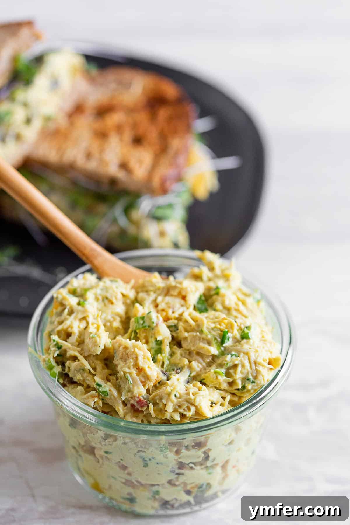 Zesty Curried Greek Yogurt Chicken Salad 5 chicken salad with curry in a bowl. A bowl of creamy chicken salad infused with curry, ready to be served or enjoyed.