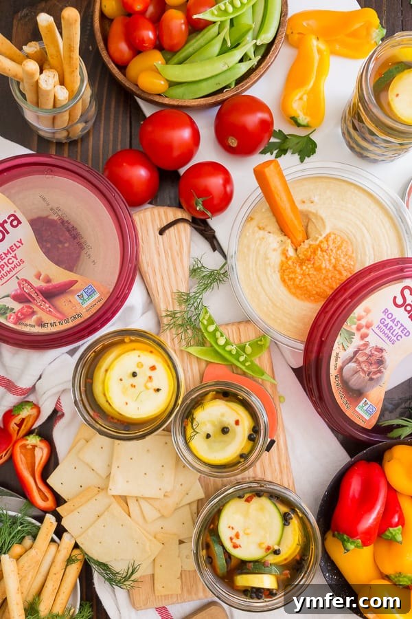 Zesty Zucchini Zingers 3 A vibrant snack board featuring sweet and spicy zucchini pickles alongside hummus and fresh vegetables, perfect for entertaining guests.