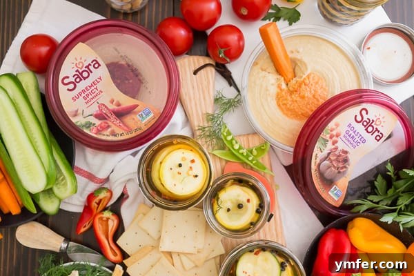 Zesty Zucchini Zingers 7 Sweet and spicy zucchini pickles beautifully arranged on a colorful snack board with fresh vegetables and dips, highlighting their versatility.
