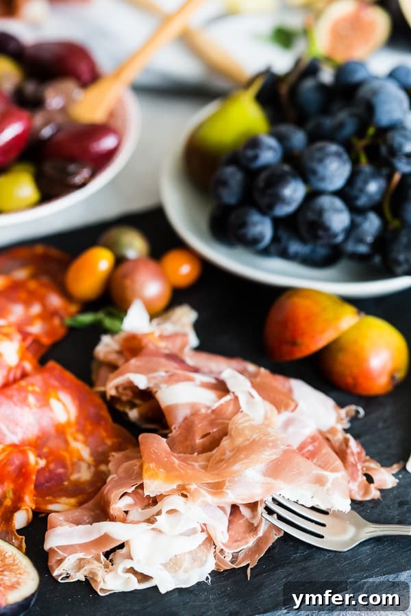 Gourmet Italian Antipasto Board 3 Close-up shot of a variety of exquisite Italian meats and fresh, vibrant fruits elegantly arranged on the Ultimate Italian Antipasto Platter, highlighting the quality and colorful display.