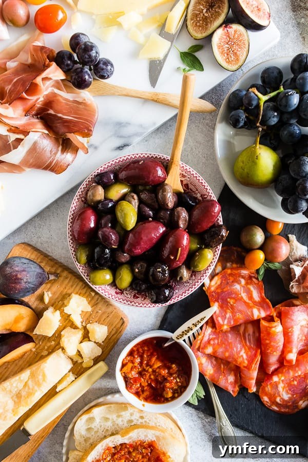 Gourmet Italian Antipasto Board 5 A beautifully arranged Ultimate Italian Antipasto Platter, showcasing a harmonious blend of gourmet Italian cheeses, cured meats, fresh fruits, nuts, and delectable spreads, ready for serving.