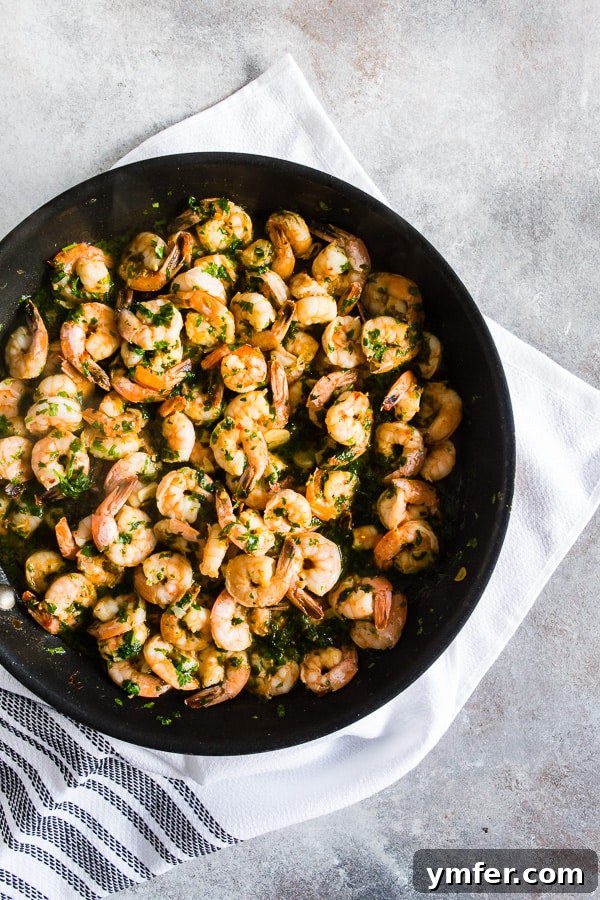 Hot Garlic Cilantro Shrimp 2 Vibrant Spicy Garlic Cilantro Shrimp served steaming hot in a rustic cast-iron skillet, generously garnished with fresh cilantro and thinly sliced garlic.