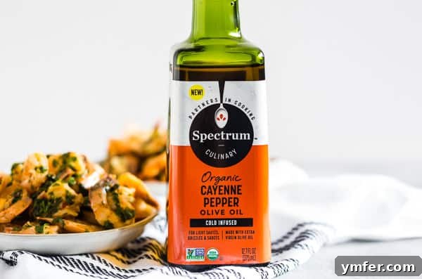 Hot Garlic Cilantro Shrimp 3 A pristine bottle of Spectrum Organic Cayenne Pepper Olive Oil sitting elegantly on a clean wooden table, emphasizing its natural and organic quality.