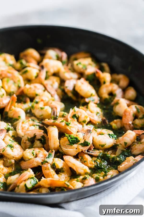 Hot Garlic Cilantro Shrimp 6 A close-up of the perfectly cooked Spicy Garlic Cilantro Shrimp sizzling gently in a black skillet, emphasizing its readiness to be enjoyed.