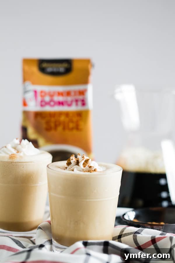 Pumpkin Spice Power Brew 2 A refreshing Pumpkin Spice Coffee Protein Shake in a tall glass, beautifully presented with a backdrop of coffee beans and fall decor.