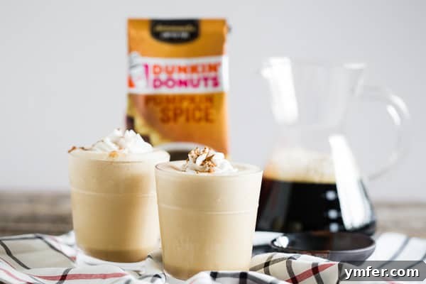 Pumpkin Spice Power Brew 5 A Pumpkin Spice Coffee Protein Shake in a glass, next to a pitcher of freshly brewed iced coffee, suggesting its key ingredient.